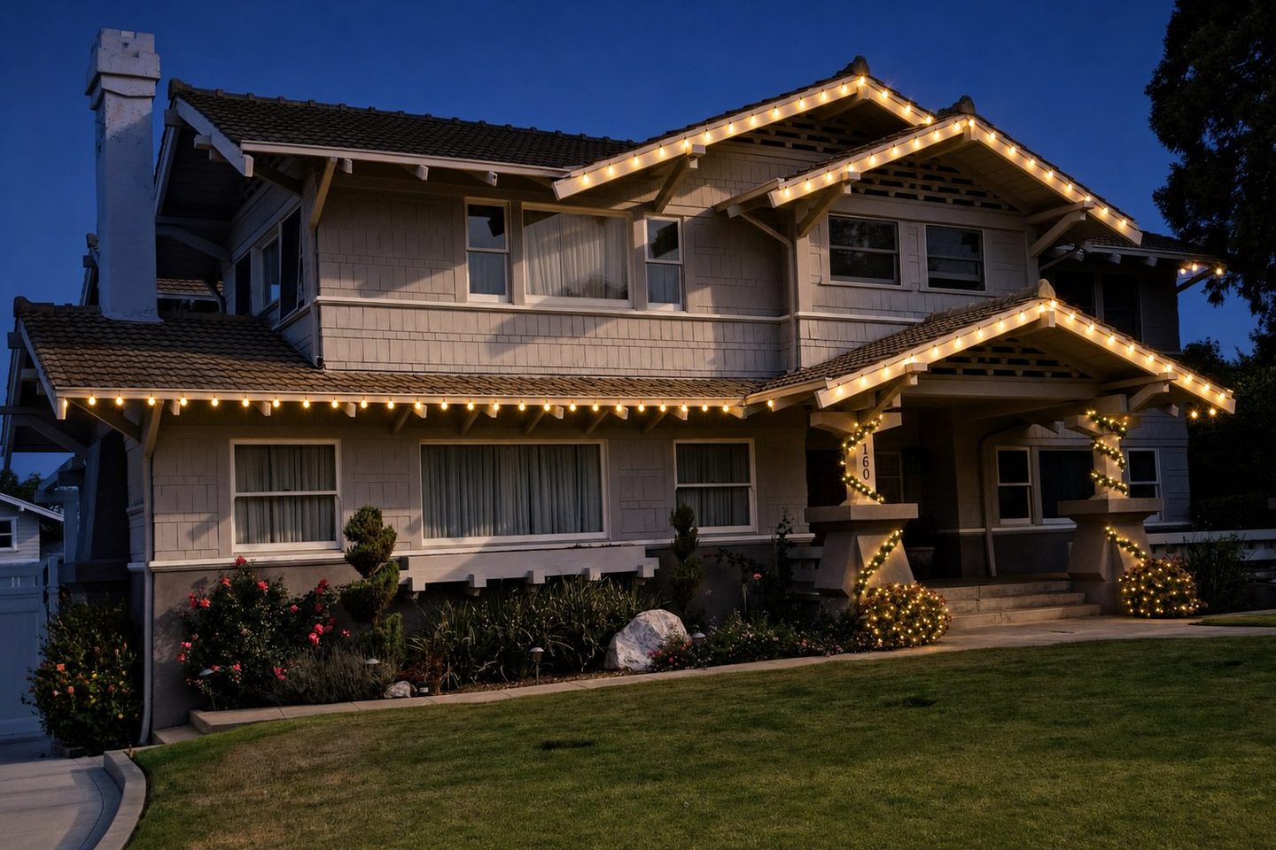 The same home rendered with a professional warm-white Christmas lighting installation at twilight