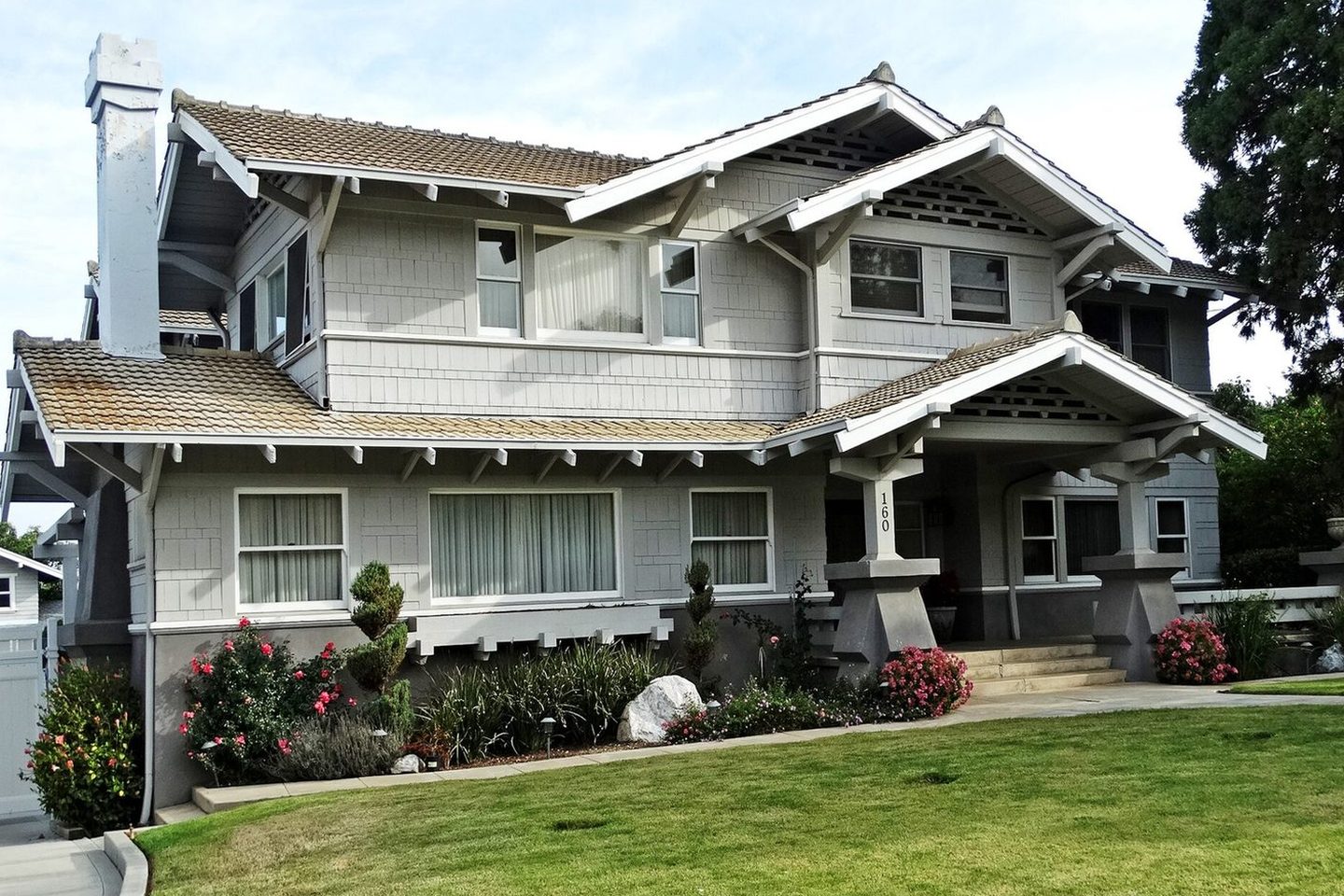 A craftsman home photographed in daylight — the photo you'd snap from the driveway